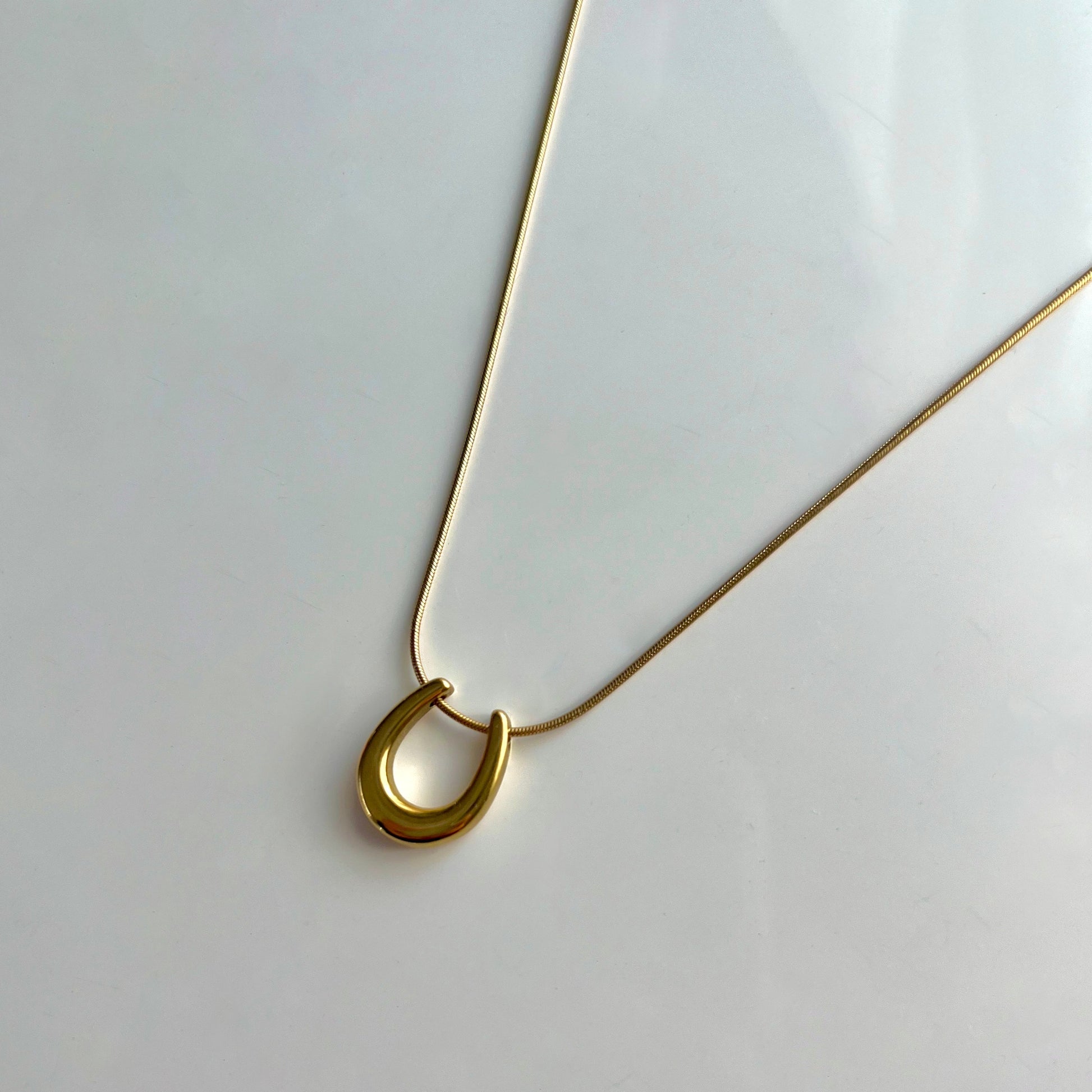 Lucky Horseshoe Gold-Plated Necklace - Symbol of Elegance and Good Fortune by Baleh Jewels. Elevate your style with this timeless accessory, meticulously crafted for lasting charm and sophistication.